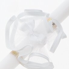 Decorating the baptismal candle with a tulle bow